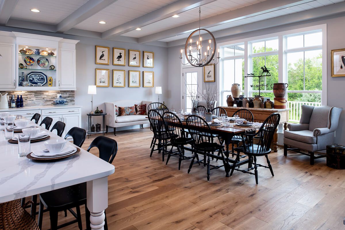 Spacious, elegant dining room with wooden floors and large windows.
